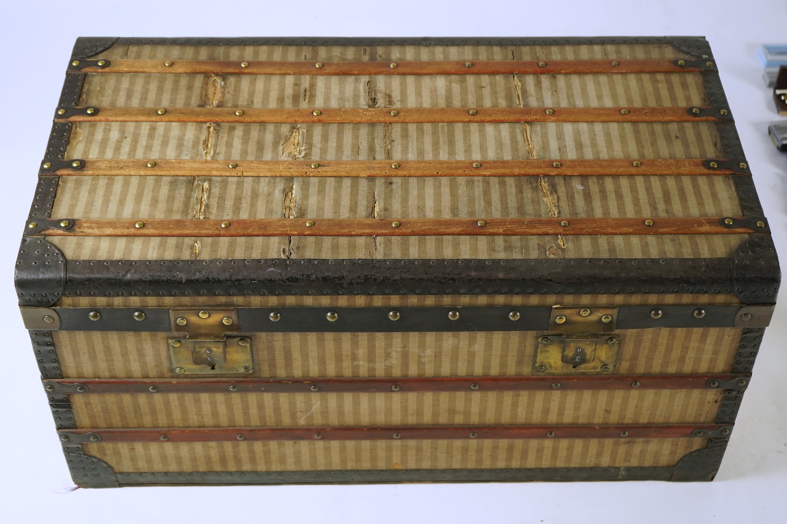 A vintage Louis Vuitton trunk with paper label to the interior numbered 142678, height 43cm, width 90cm, depth 48cm